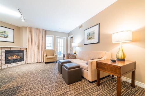 a living room with a couch and a fireplace at Horseshoe Valley Suites - The Aurora in Shanty Bay