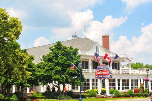 a white house with american flags in front of it at The Frankenmuth Christmas Wonderland House - Hot in Birch Run