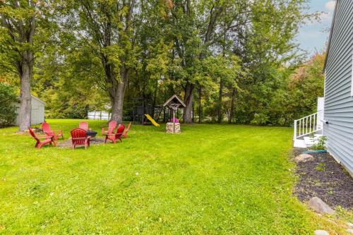 a yard with red chairs and a playground at The Frankenmuth Christmas Wonderland House - Hot in Birch Run