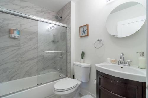 a bathroom with a shower and a toilet and a sink at McCormick Place 420 friendly 3b/2b with optional Parking for up to 8 guests in Chicago