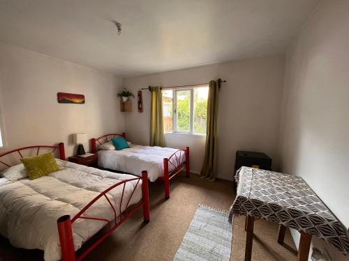 a bedroom with two beds and a window at Espacio Mycelium in Coihaique