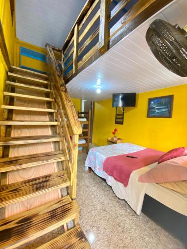 a bedroom with a bunk bed and a staircase at Pousada & Camping Tubarão in Ilha do Mel