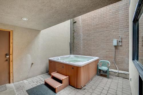 a hot tub in a room with a chair at Park Avenue by All Seasons Resort Lodging in Park City