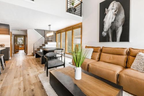 a living room with a couch and a table with a horse on the wall at Payday by All Seasons Resort Lodging in Park City