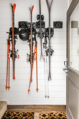 a bunch of skis are hanging on a wall at Payday by All Seasons Resort Lodging in Park City