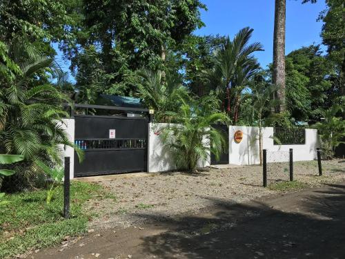 a black and white fence with trees behind it at Casa ANA KIMBA in Puerto Viejo