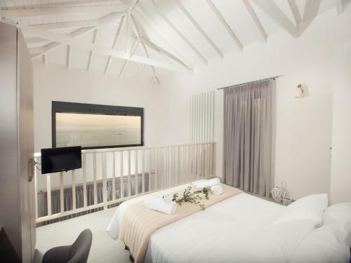 a bedroom with two beds and a flat screen tv at Petra Thea in Kalamata