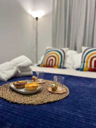 a breakfast tray with food on a bed with a bed at The Pearl of Lisbon in Lisbon