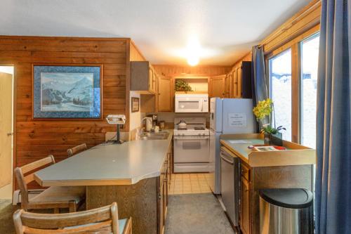 a kitchen with wooden cabinets and a counter top at Darwin's in Girdwood