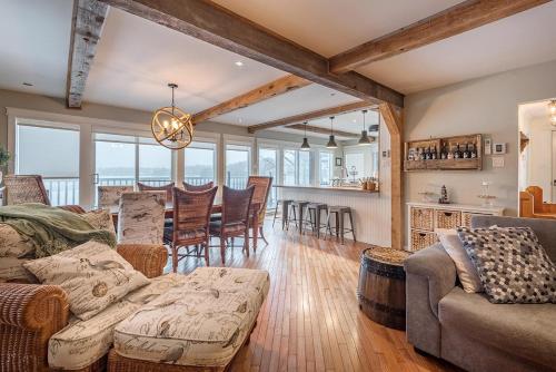 a living room with a couch and a table at Breathtaking Lake View With Spa Chalet 360 in Chertsey