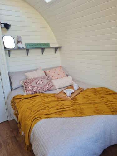a bedroom with a bed with a tray on it at Two Peas in a Pod in Holyhead