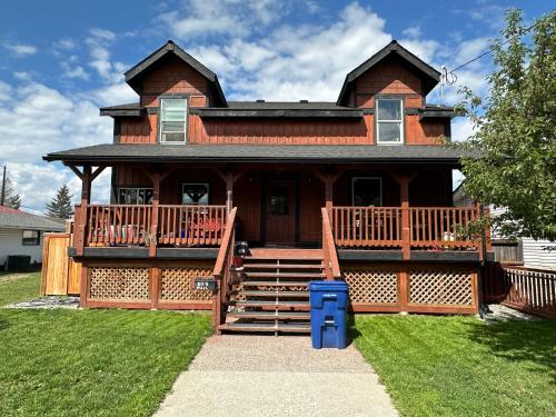 a large wooden house with a large deck at Beautiful Suite In Cranbrook! in Cranbrook