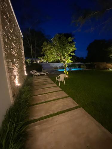 a pathway leading to a yard at night at La Escondida Samber in San Bernardino