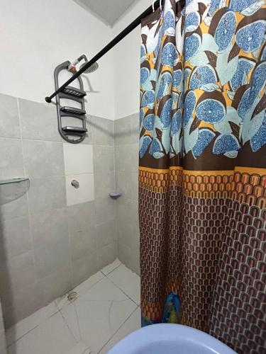 a shower with a shower curtain in a bathroom at ARMANI in Puerto Colombia