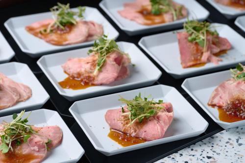 a group of white plates filled with meat and sauce at Via Inn Abeno Tennoji in Osaka