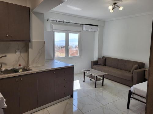 a kitchen and living room with a couch and a table at City Stay Kavala in Kavala