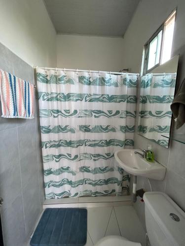 a bathroom with a shower curtain and a sink at Amiri in Puerto Colombia