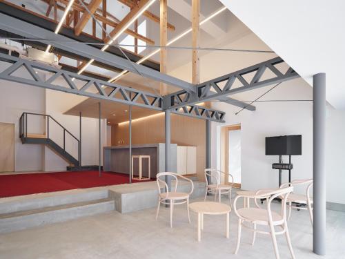 a room with tables and chairs and a stage at 別邸 仲乃家 in Tochigi