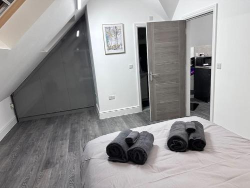 a bedroom with a bed with black towels on it at Flat in Leicester! in Leicester