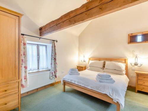 a bedroom with a bed and a window at The Barn - Uk44514 in Tetney