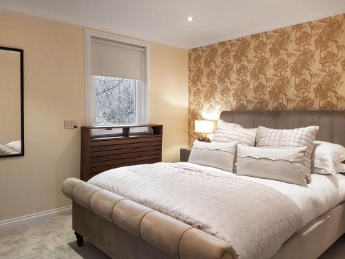 a bedroom with a large bed and a window at Leven Lodge 1 - Uk46042 in Balloch