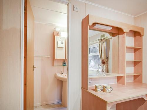 a small bathroom with a sink and a mirror at Cabin 29 - Uk45926 in Newtown