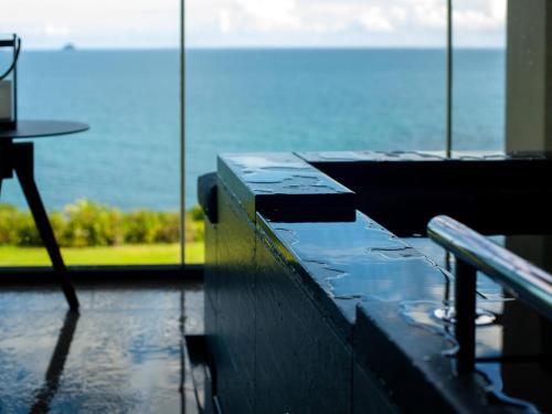 a table in a room with a view of the ocean at GOTO RETREAT by Onko Chishin in Goto