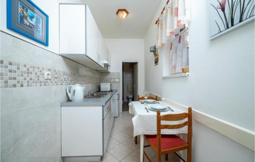 una pequeña cocina con encimera y mesa en Gorgeous Apartment In Rabac With Wi-Fi, en Rabac