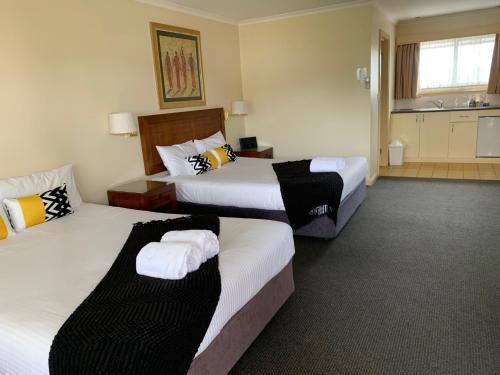 Postel nebo postele na pokoji v ubytování Armidale Pines Motel