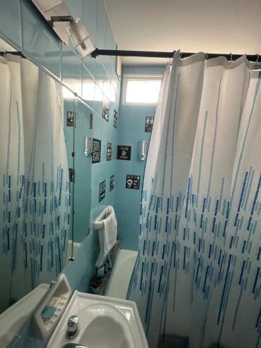 a bathroom with a sink and a shower at CorrientesNice in Buenos Aires
