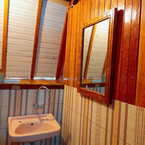 a bathroom with a sink and a mirror at Sunari Beach Resort 2 in Selayar