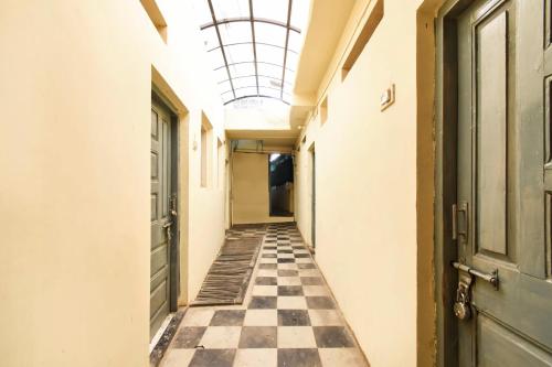 an empty hallway with a checkered floor and a ceiling at SPOT ON 64570 Hotel Deepali Lodging in Aurangabad