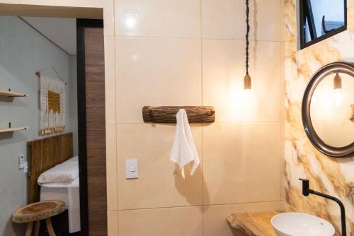 een badkamer met een wastafel en een spiegel bij Pousada Carcará in Fortim