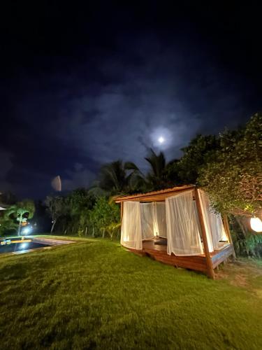 a luxury tent on the lawn at night at Costa do Sauipe Casa dentro do complexo hoteleiro in Costa do Sauipe