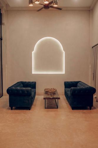 a living room with two couches and a coffee table at Yum Kaax Boutique Villa in Tulum