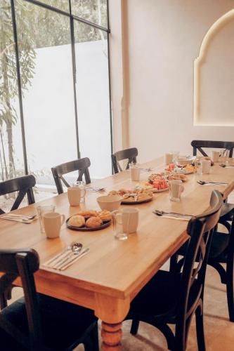 a wooden table with plates of food on it at Yum Kaax Boutique Villa in Tulum