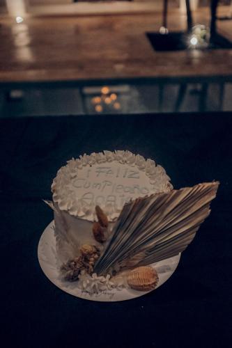 a birthday cake sitting on a plate on a table at Yum Kaax Boutique Villa in Tulum