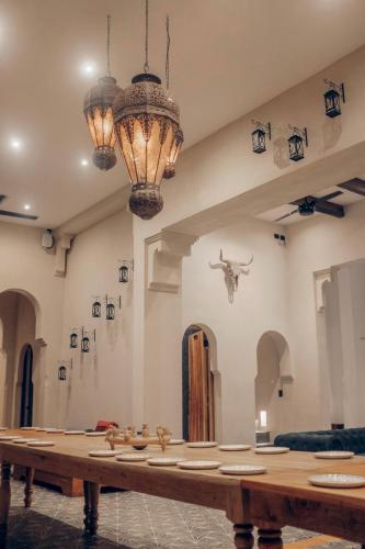 a large table in a room with chandeliers at Yum Kaax Boutique Villa in Tulum