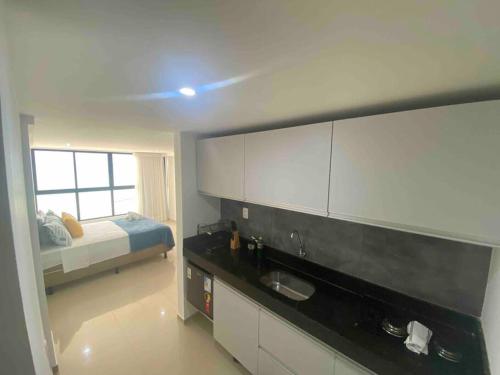 - une cuisine avec évier et un lit dans une chambre dans l'établissement Pé na areia com vista mar 203, à João Pessoa