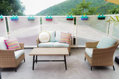 a patio with a couch and two chairs and a skate park at El Yunque Waterfalls Romantic Stay at Casa Parcha in Naguabo
