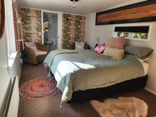 a bedroom with a large bed and a window at 'Haumoana' in Olde Beach. in Waikanae