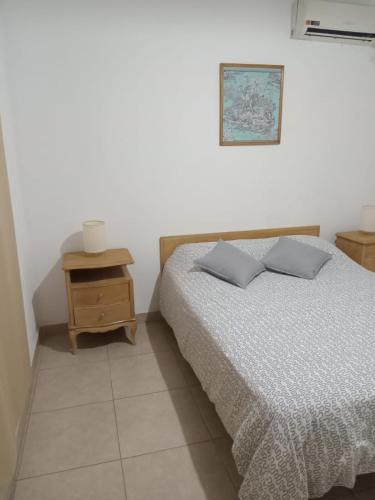 1 dormitorio con cama y mesita de noche con cama sidx sidx sidx sidx sidx sidx en Departamento céntrico 2 en Mendoza