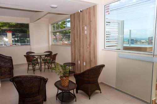 a room with chairs and tables and a window at Pousada Roberto Monteiro - Frente Mar in Florianópolis