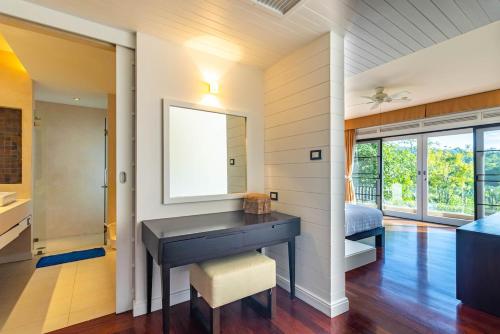 a bathroom with a sink and a mirror at 3BR Family Home in Laguna — 100m walk from beach in Phuket Town