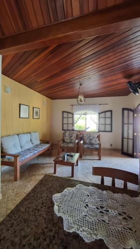 a living room with a couch and a table at Big Beach Casa Temporada in Mangaratiba