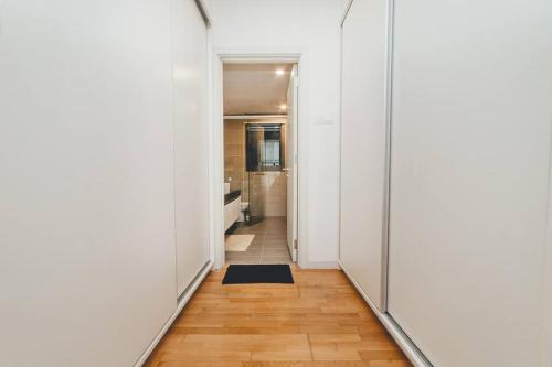 a hallway with white walls and wooden floors at Classical Cozy Iskandar Residence 3BR nr Legoland by Our Stay in Nusajaya