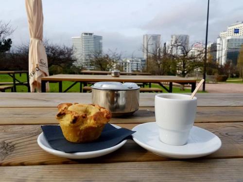 a muffin and a cup of coffee on a table at LDapartments - Spacious Lisbon Haven w/Lift&Garage in Lisbon