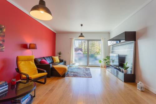 a living room with a couch and a tv at LDapartments - Spacious Lisbon Haven w/Lift&Garage in Lisbon
