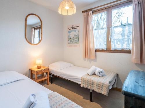 a room with two beds and a mirror at Charmant appartement 4 pers au pied des pistes à Courchevel Le Praz - FR-1-568-49 in Courchevel