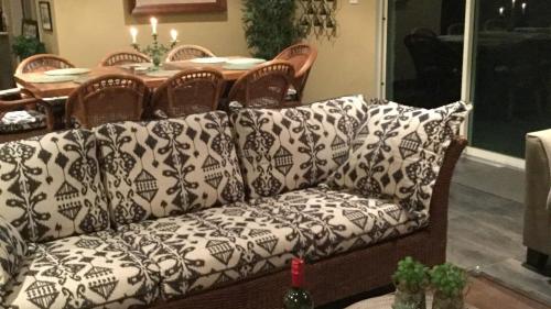 a couch sitting in a living room with a table at Wirreanda Retreat Acreage in Macmasters Beach